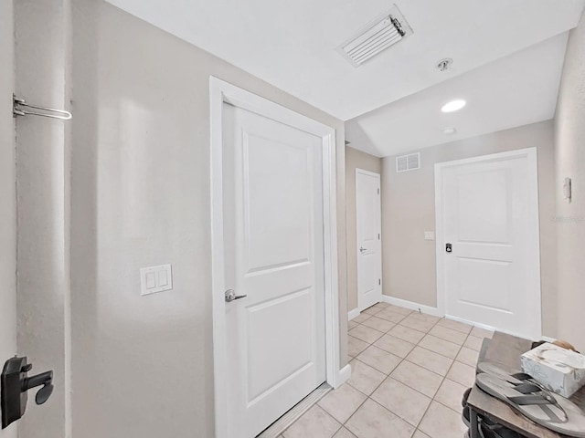 corridor featuring light tile patterned floors