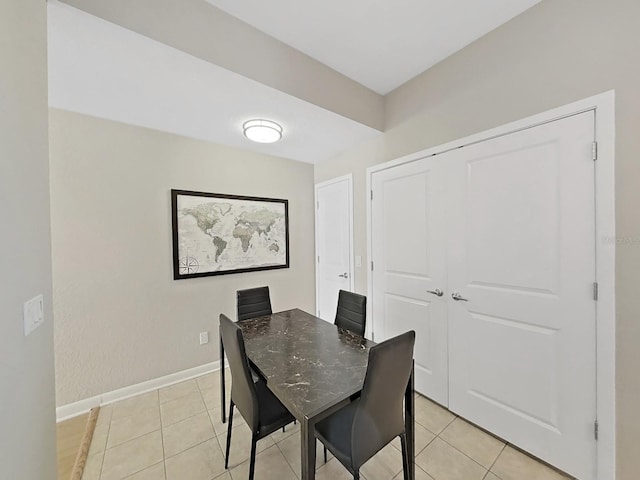 dining space featuring light tile patterned flooring