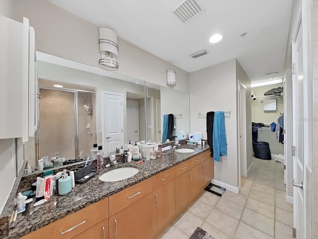 bathroom with vanity, tile patterned flooring, and walk in shower