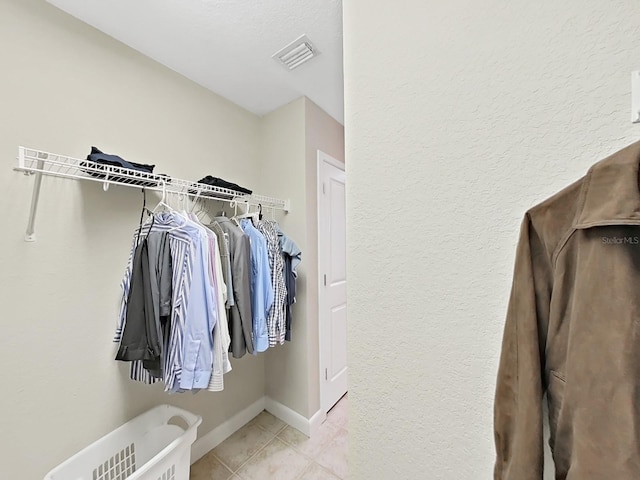 spacious closet featuring light tile patterned flooring