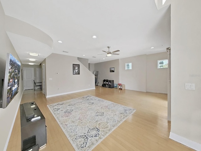 living room with ceiling fan and light wood-type flooring