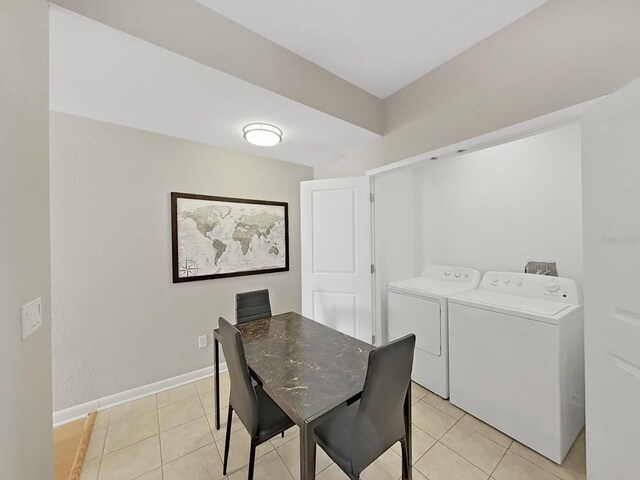 dining area featuring washer and dryer and light tile patterned floors