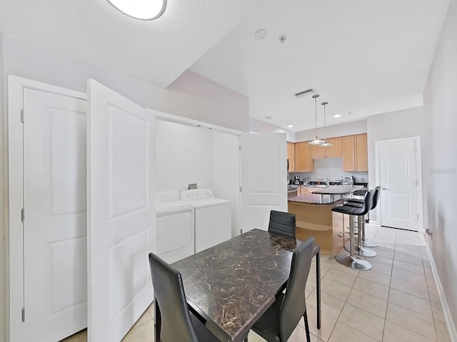 tiled dining room with independent washer and dryer