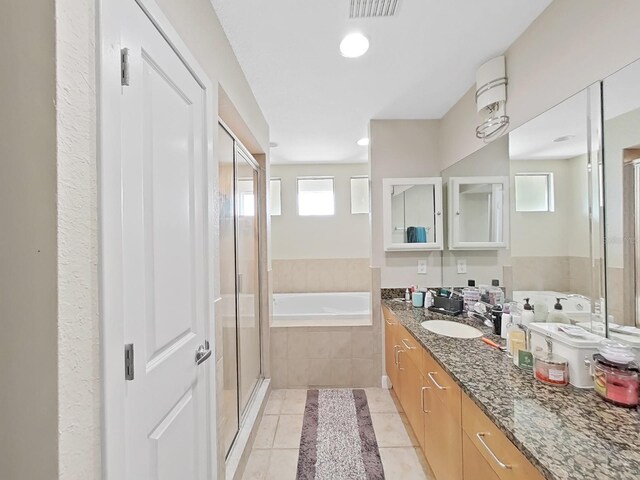 bathroom featuring vanity, tile patterned floors, and separate shower and tub