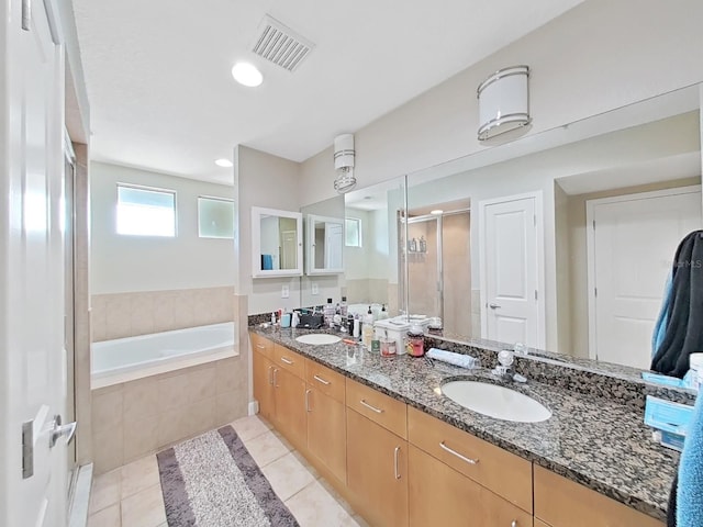 bathroom featuring vanity, tile patterned floors, and plus walk in shower