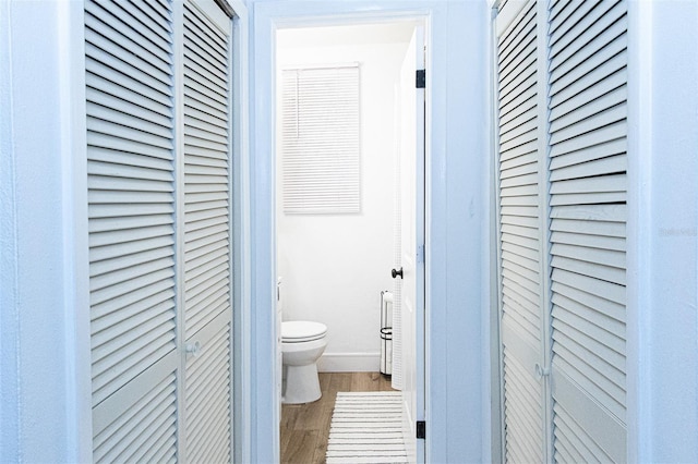 bathroom with hardwood / wood-style floors and toilet