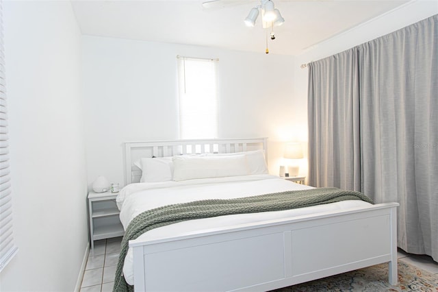 tiled bedroom with ceiling fan