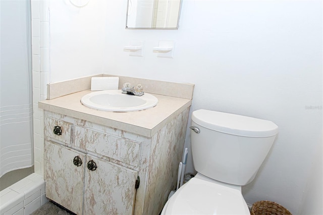 bathroom featuring vanity, toilet, and walk in shower