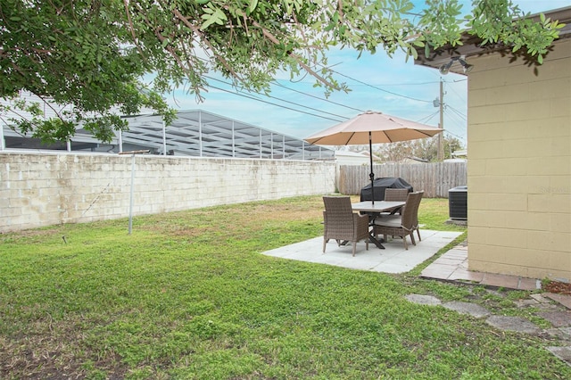 view of yard with central AC and a patio