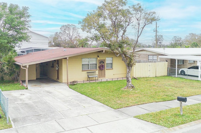 ranch-style house featuring a carport and a front lawn