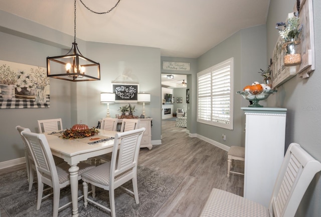 dining room featuring wood-type flooring and a notable chandelier