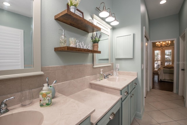 bathroom with french doors, tile patterned floors, vanity, and decorative backsplash