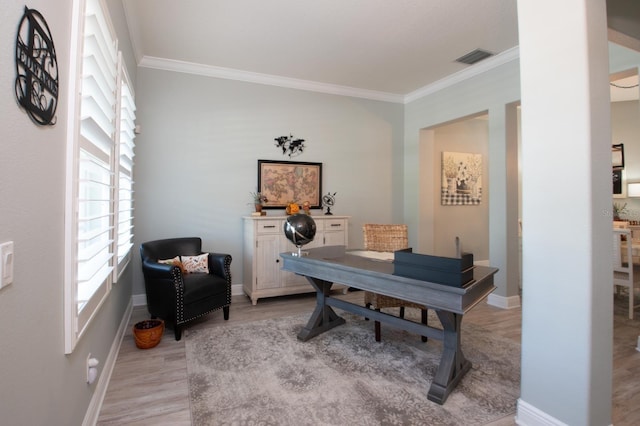 office with ornamental molding and light hardwood / wood-style floors