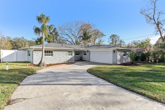 single story home featuring a garage and a front lawn