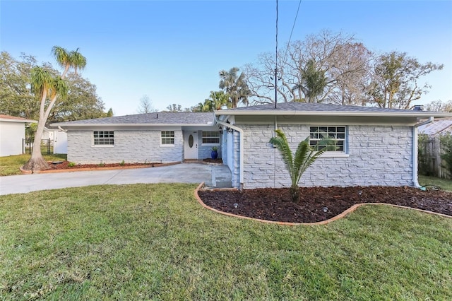 ranch-style house with a front yard and a patio