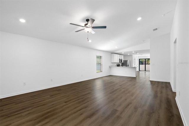 unfurnished living room featuring lofted ceiling, dark wood-type flooring, and ceiling fan