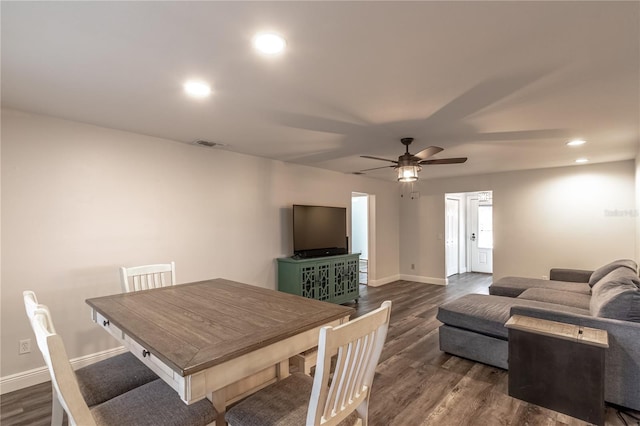 dining space with dark wood-type flooring and ceiling fan