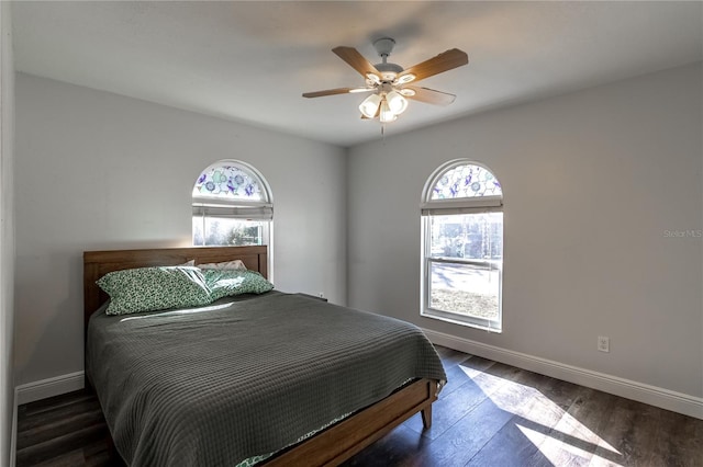 bedroom with dark wood-type flooring and ceiling fan