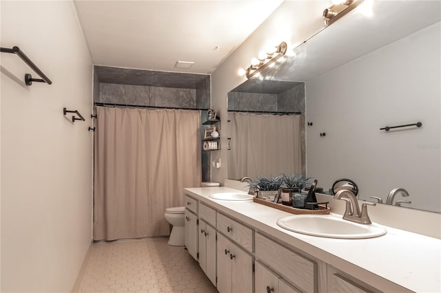 bathroom featuring tile patterned floors, vanity, toilet, and curtained shower