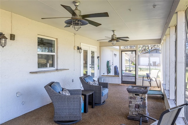 sunroom featuring ceiling fan