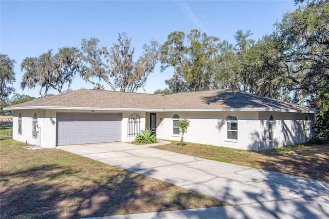 ranch-style home with a garage and a front yard