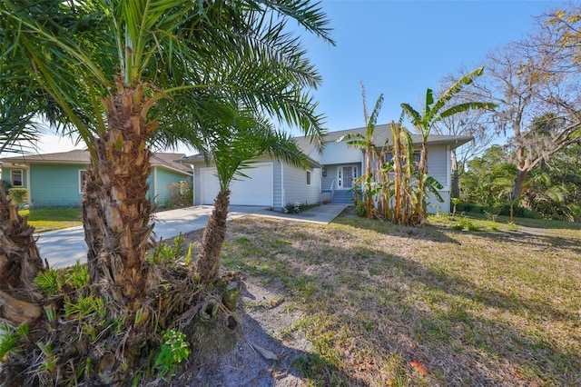 view of front of house with a garage and a front lawn