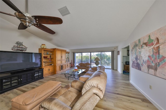 living room with vaulted ceiling and light hardwood / wood-style floors