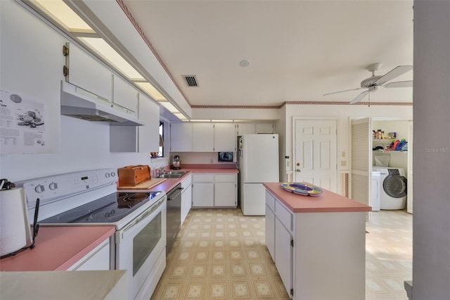 kitchen featuring sink, white cabinets, a center island, ceiling fan, and white appliances