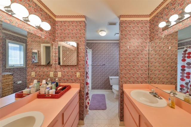 bathroom featuring vanity, tile patterned floors, crown molding, and toilet