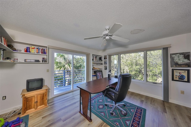 office area featuring ceiling fan, a textured ceiling, and light hardwood / wood-style floors