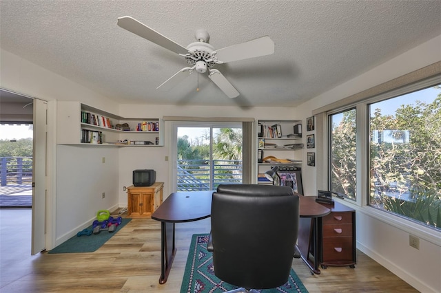 office space with ceiling fan, hardwood / wood-style flooring, and a textured ceiling