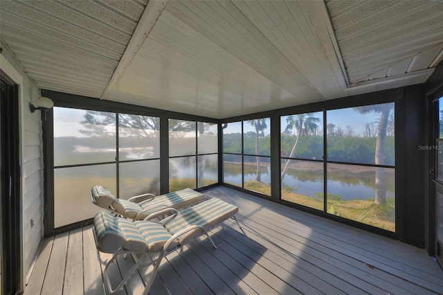 unfurnished sunroom with a water view