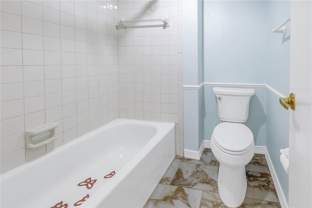 bathroom featuring tiled shower / bath and toilet