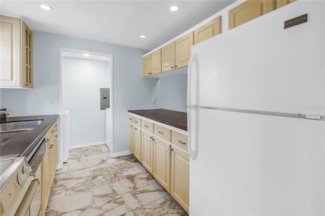 kitchen featuring white refrigerator, sink, and electric panel