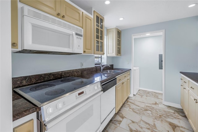 kitchen with sink, white appliances, and cream cabinets