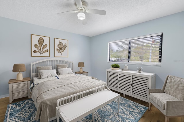 bedroom featuring ceiling fan, dark hardwood / wood-style floors, and a textured ceiling