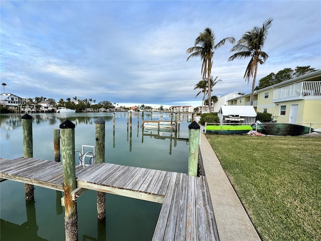 dock area featuring a lawn and a water view