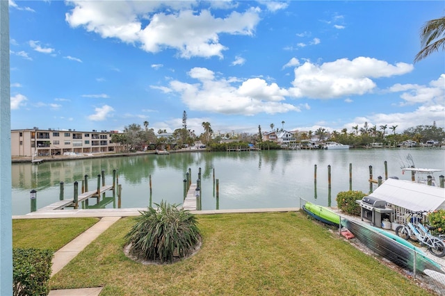 view of dock featuring a yard and a water view