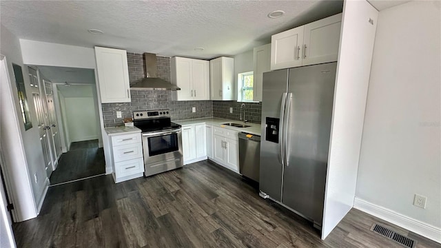 kitchen with stainless steel appliances, sink, wall chimney range hood, and white cabinets