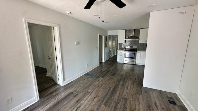 kitchen with white cabinetry, dark hardwood / wood-style flooring, decorative backsplash, stainless steel range with electric stovetop, and wall chimney exhaust hood