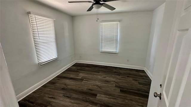 spare room with dark hardwood / wood-style flooring and ceiling fan