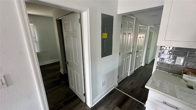 hall featuring dark wood-type flooring and electric panel