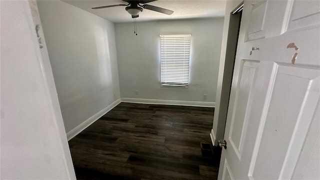 unfurnished room with ceiling fan and dark hardwood / wood-style flooring