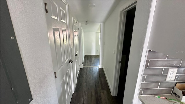 corridor with dark hardwood / wood-style floors