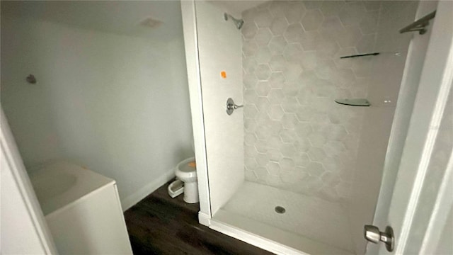 bathroom with toilet and tiled shower