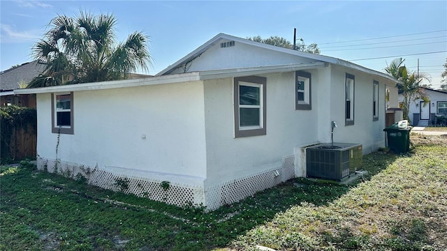 view of home's exterior featuring a yard and central air condition unit