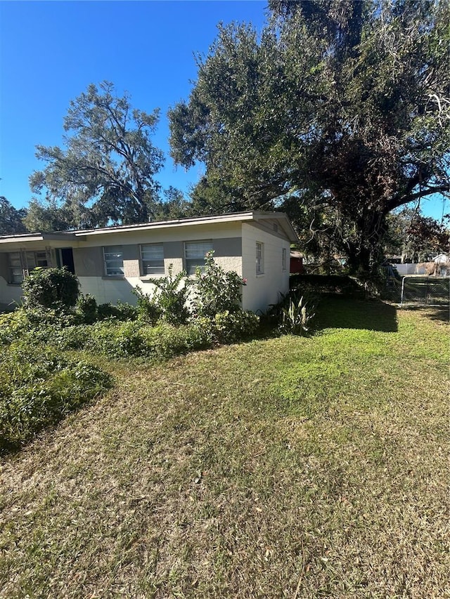 view of side of home featuring a lawn