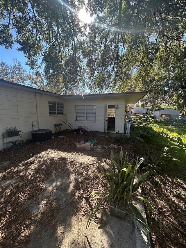 back of property featuring central air condition unit