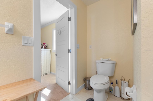 bathroom with toilet and tile patterned flooring