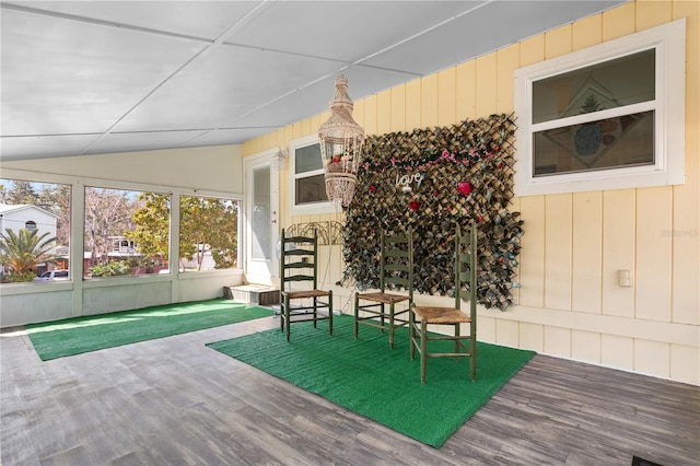 sunroom / solarium featuring vaulted ceiling